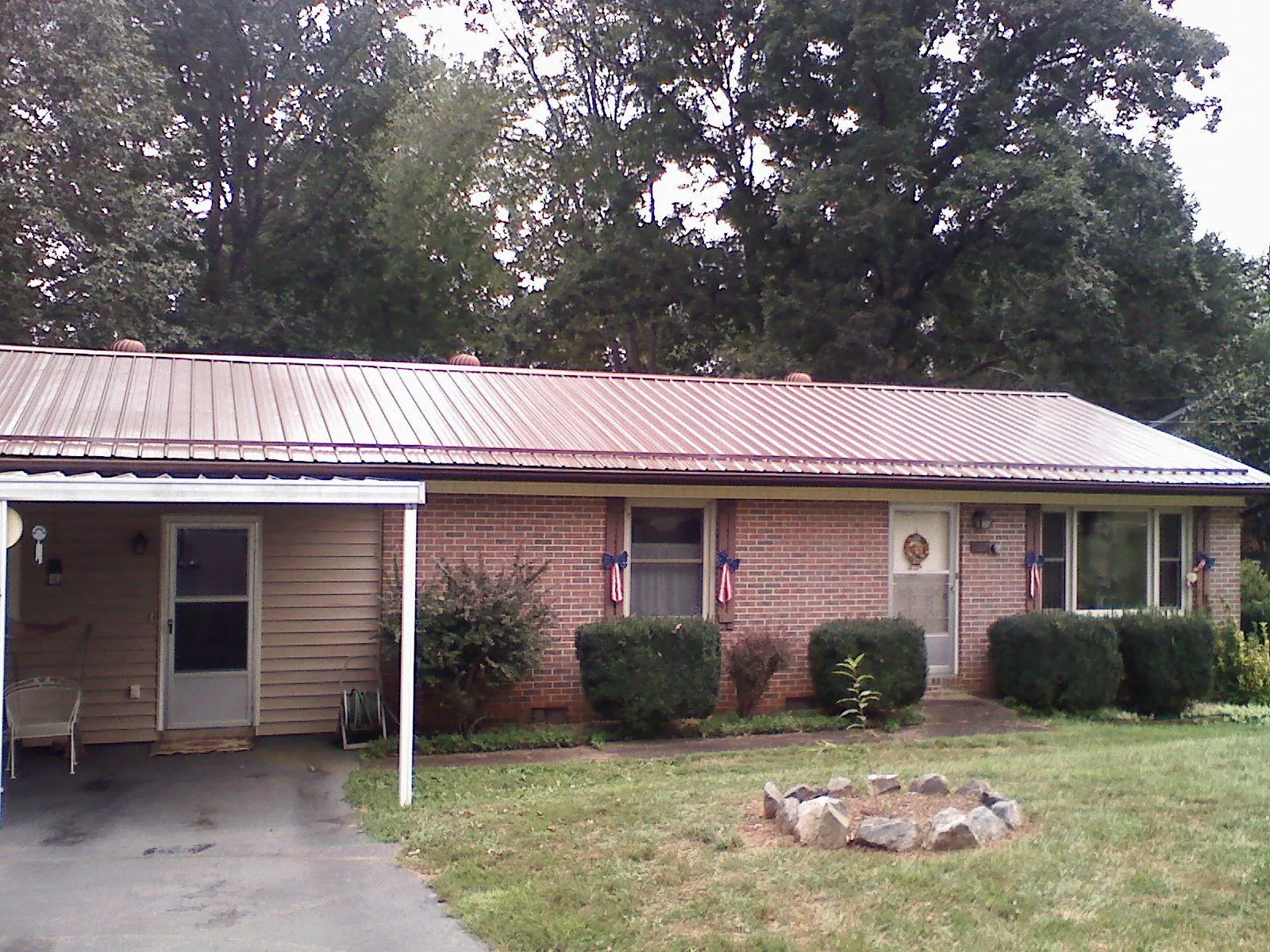 Bronze metal roof and carport on a brick ranch home — Roof Repair work by our crew in Fogelsville